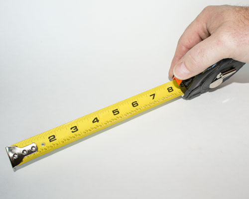 hand measuring with an extended tape measure