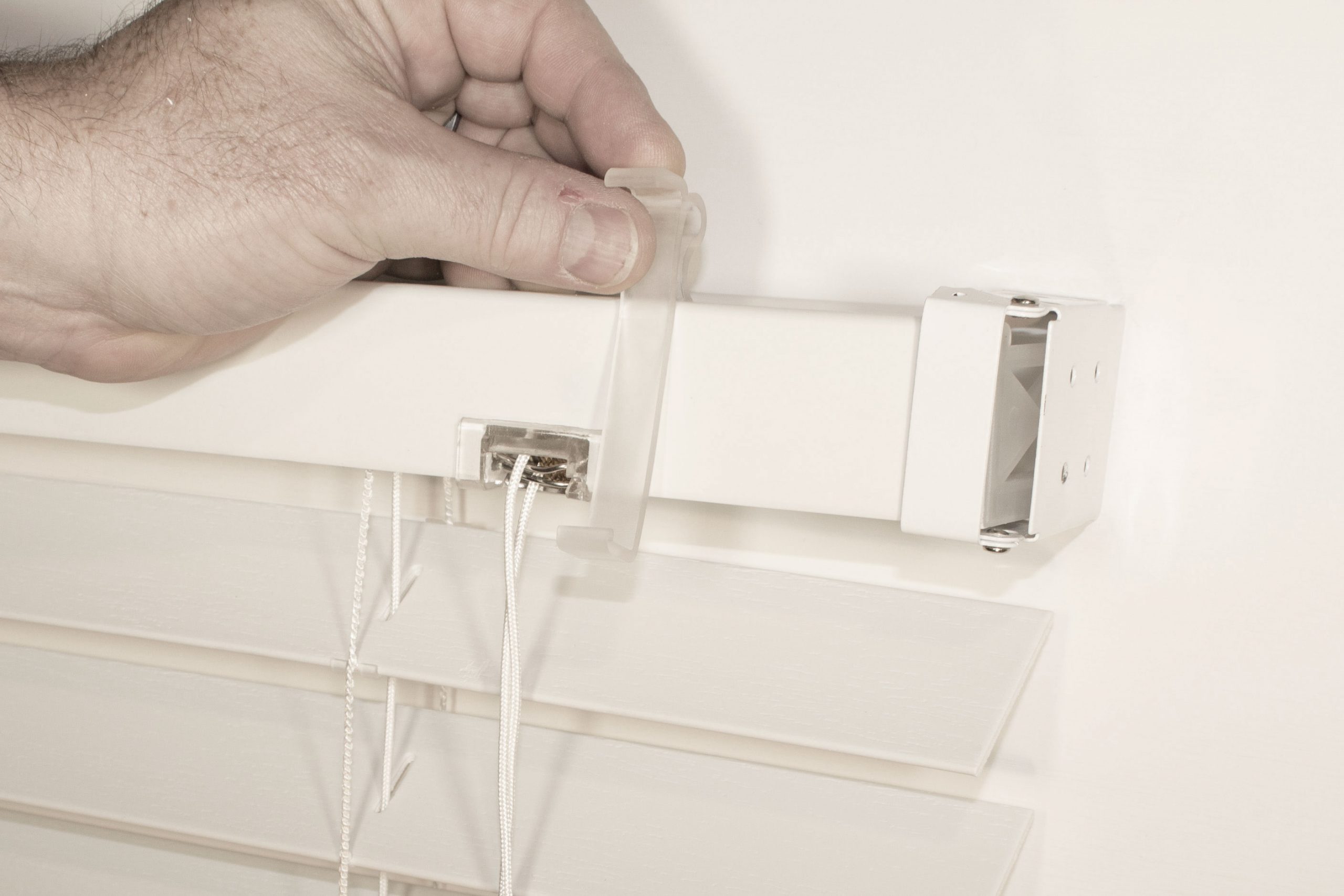 Snap clip on headrail. (remove blind first if inside mount)